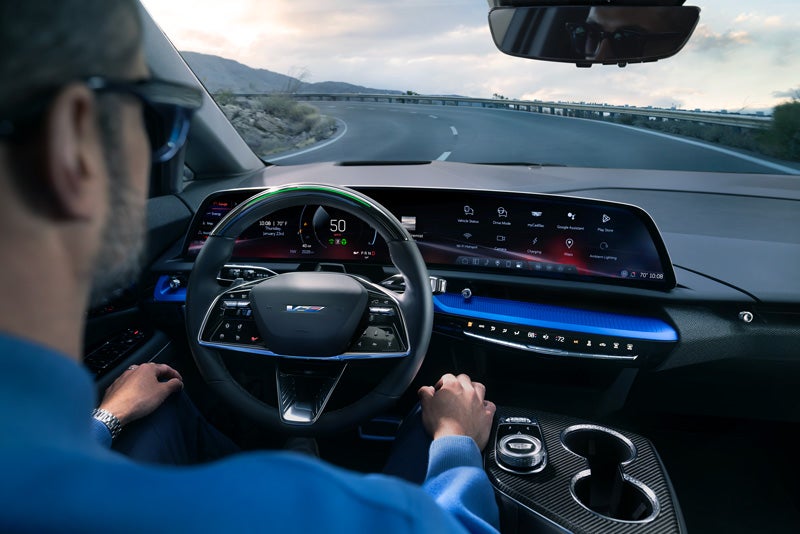 Front View of the 2026 OPTIQ-V Driving Through the Dusk Utilizing its Headlights | Spearfish GMC in Spearfish SD