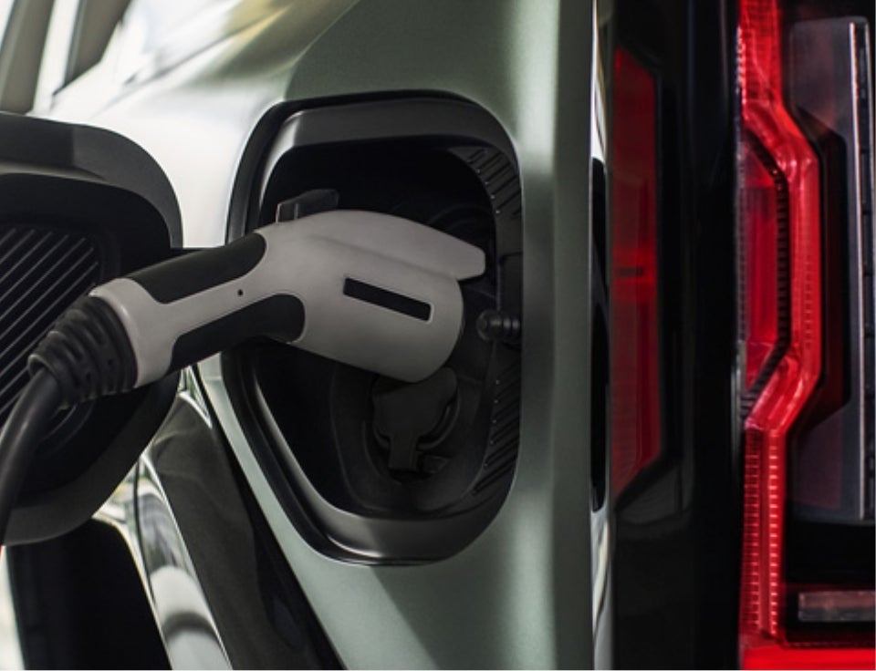 Close up of charging port with charger plugged in on a GMC Hummer EV SUV - Spearfish GMC in Spearfish SD
